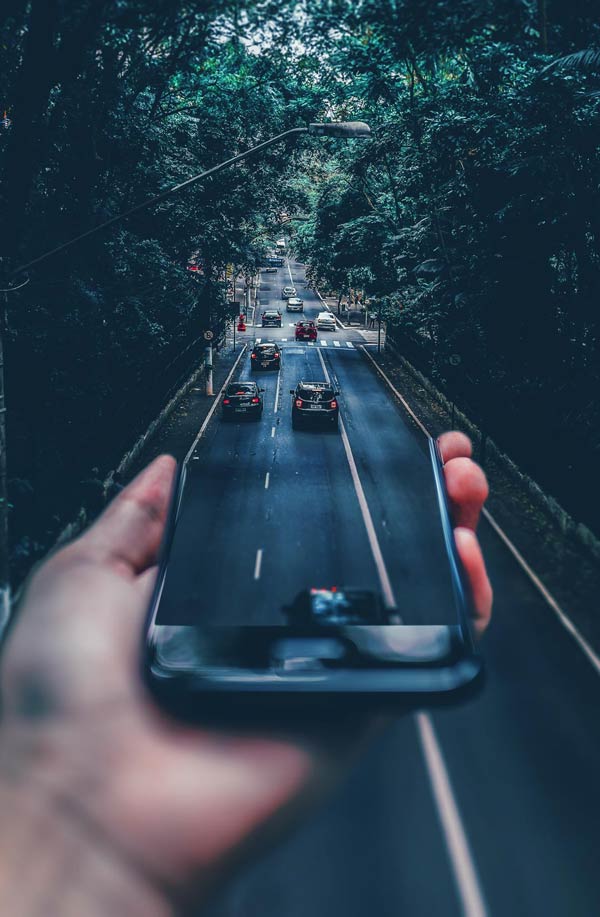 Cell phone reflecting road with cars
